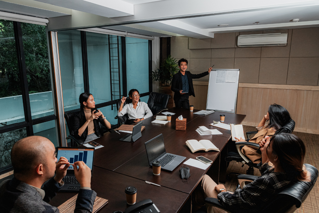 A professional team in a modern office engaged in a trust-building presentation.